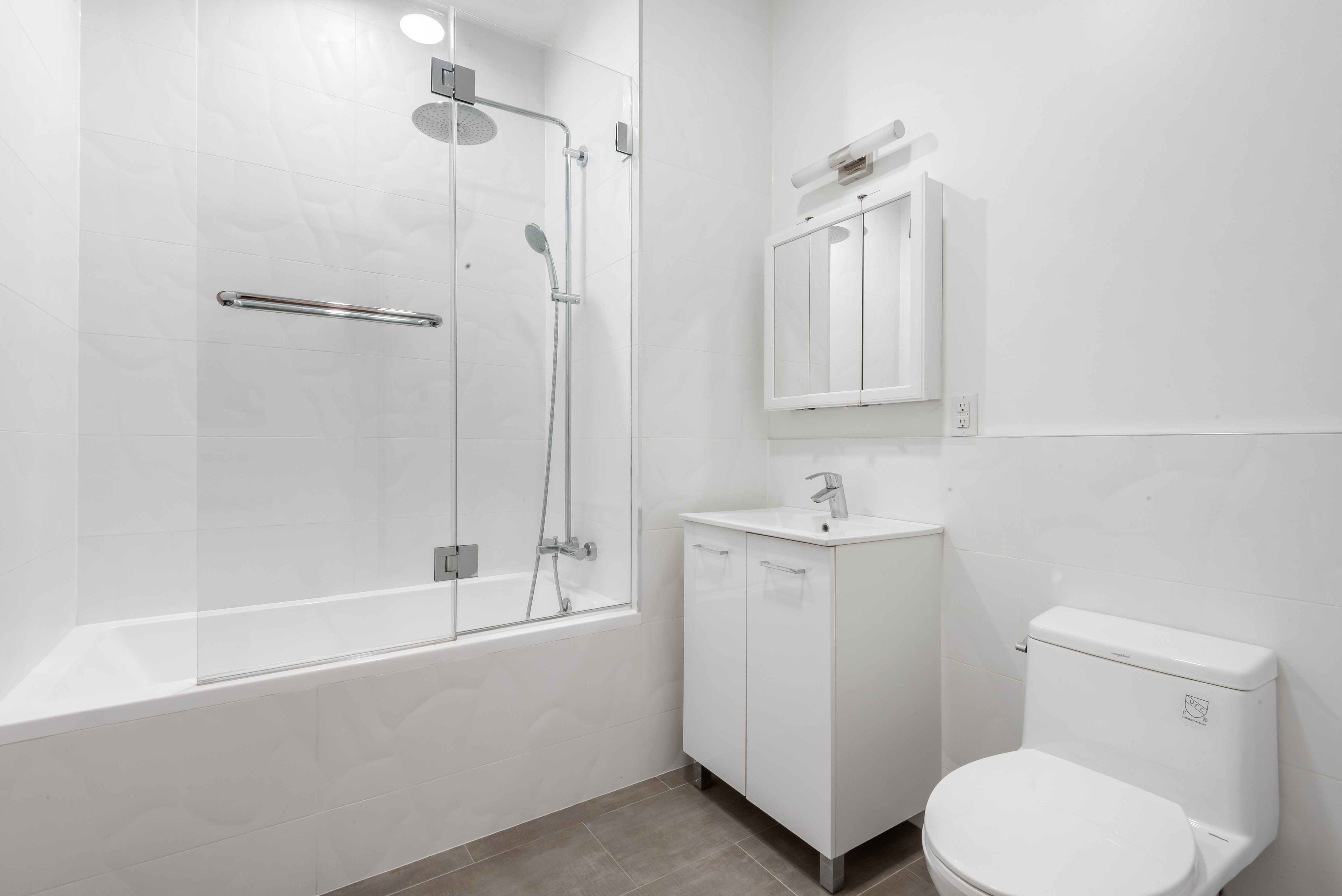 103 Broadway, Unit PH Brooklyn, NY 11249 - Photo 7 of 8 a bathroom with a toilet a sink and bathtub