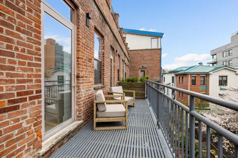 a balcony with furniture and wooden floor