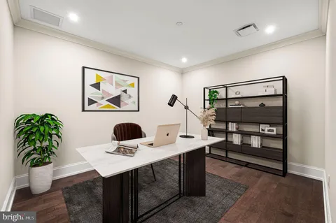 a view of a workspace with furniture and a potted plant