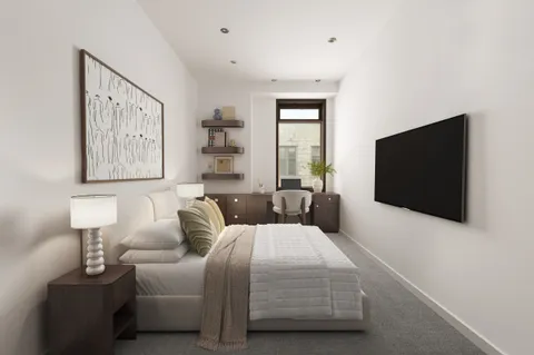 a bedroom with a bed and a flat screen tv