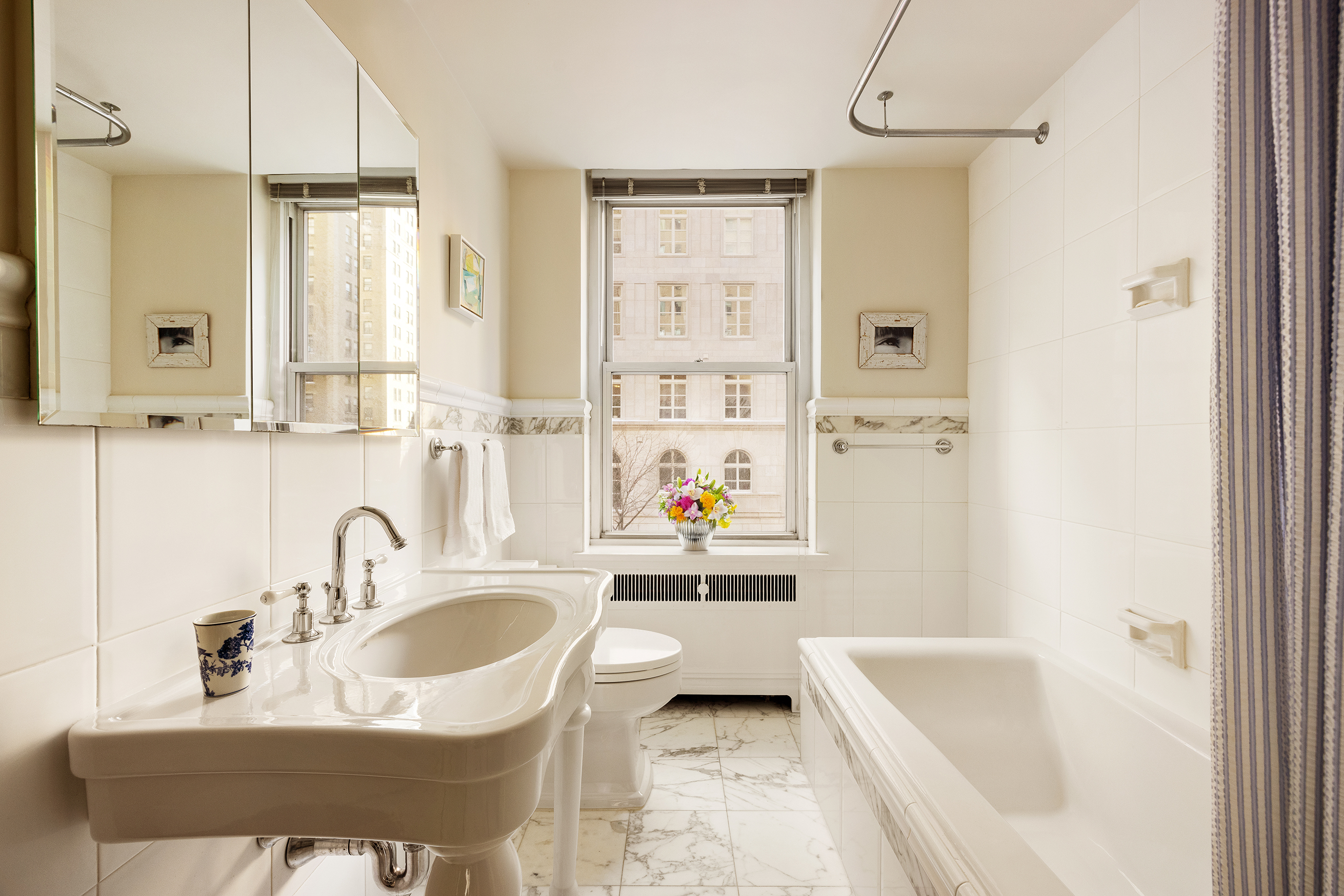 49 East 86th Street, Unit 3A Manhattan, NY 10028 - Photo 6 of 14 a bathroom with a sink a toilet and a bathtub