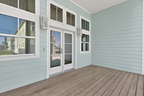 a view of a balcony with wooden floor