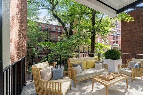 a large kitchen with stainless steel appliances a stove a sink dishwasher and a refrigerator with the bookshelf