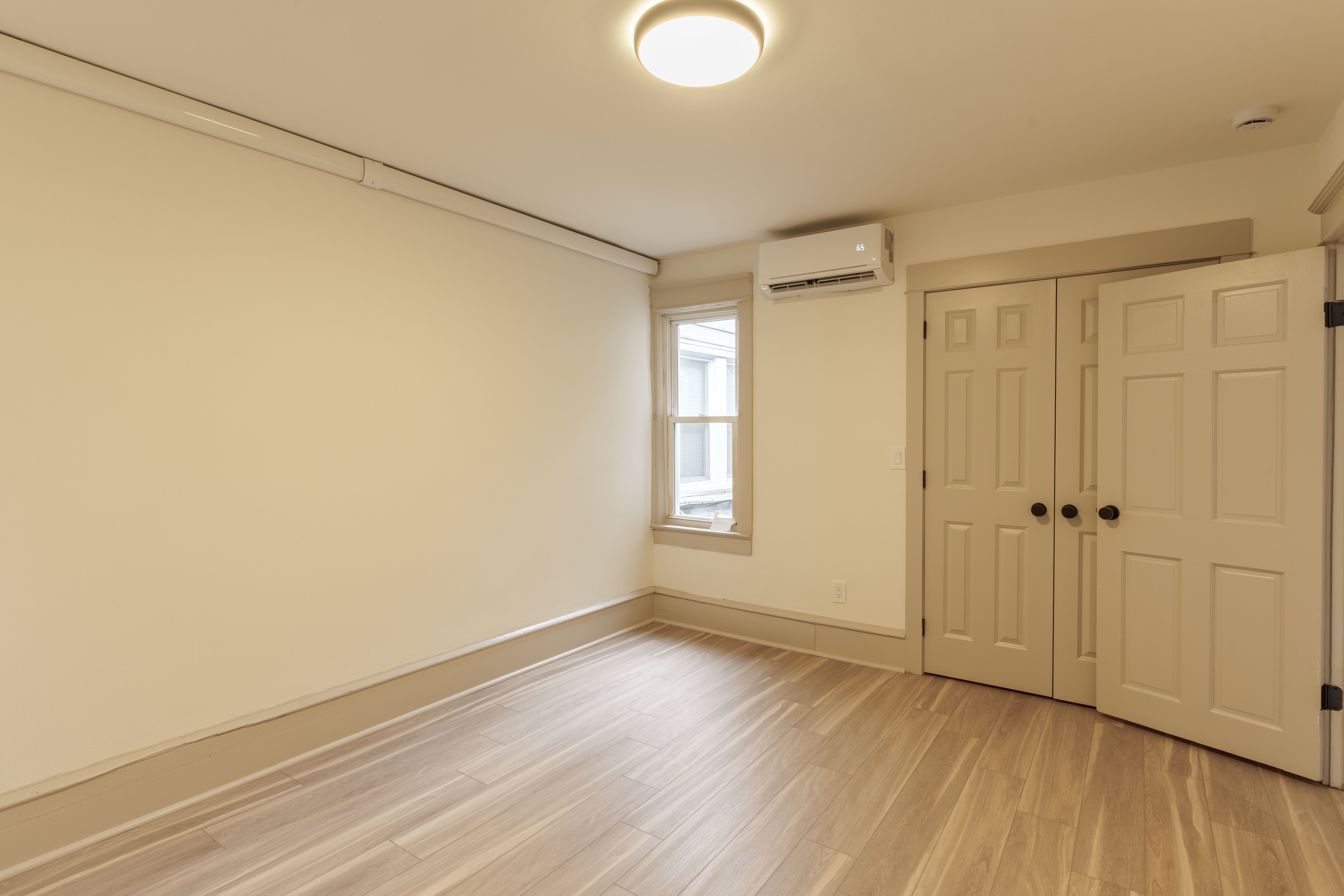 423 North Haddon Avenue Haddonfield, NJ 08033 - Photo 13 of 16 a view of an empty room with wooden floor and a window