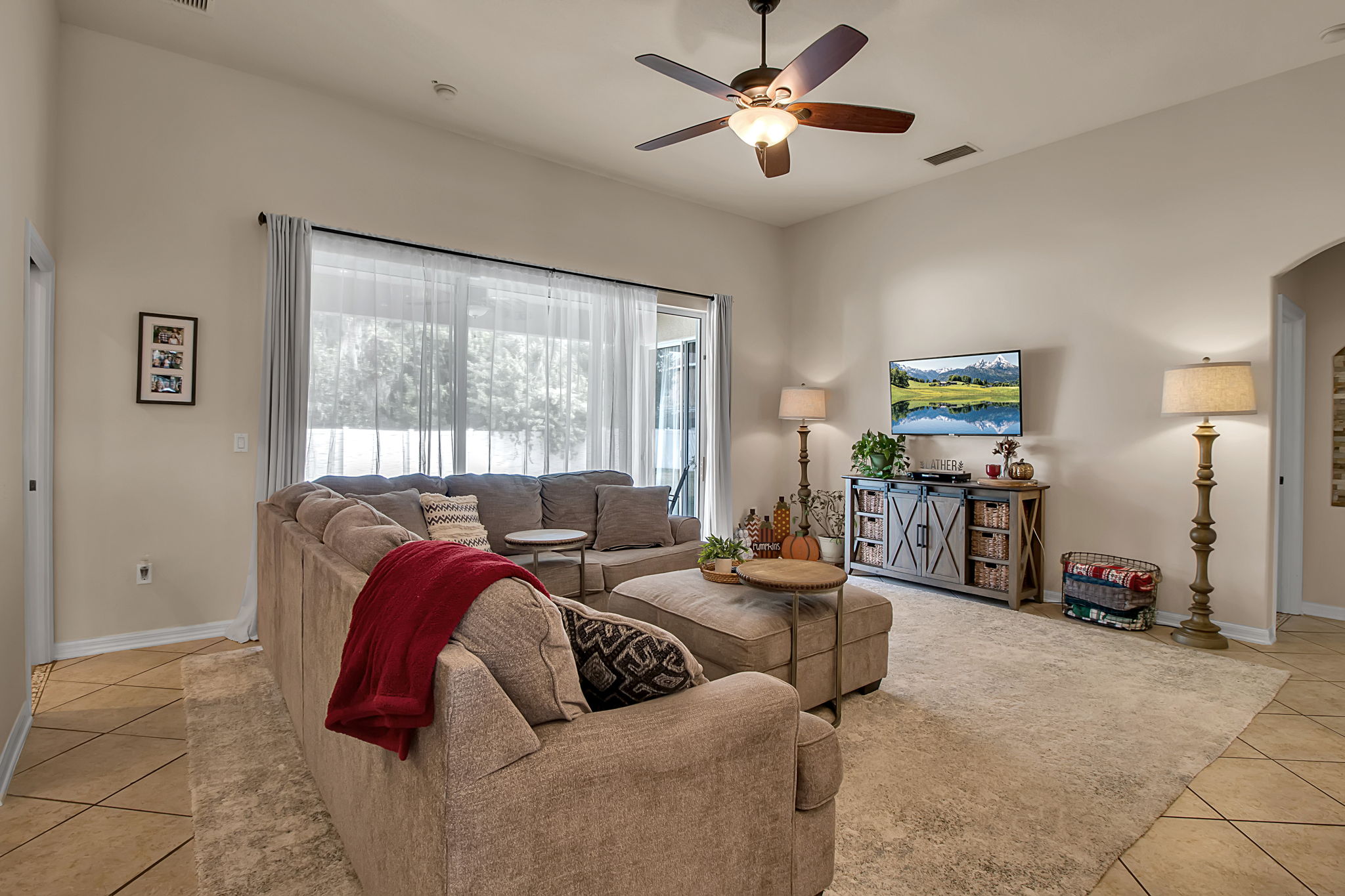 6106 34th Court East Bradenton, FL 34203 - Photo 29 of 69 a living room with furniture ceiling fan and a window