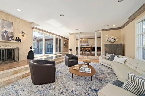 a view of a hallway with wooden floor and windows