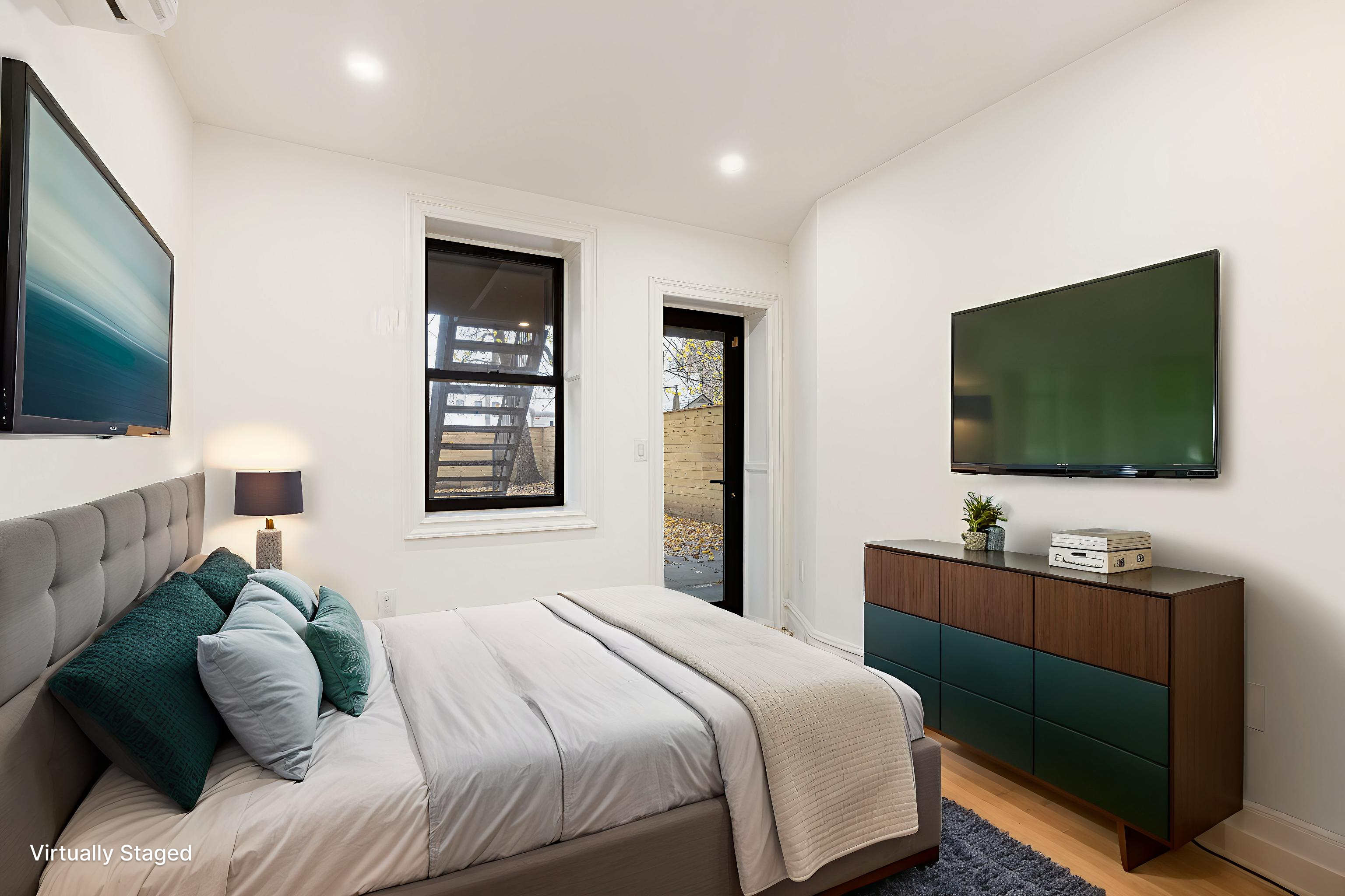 15 Verona Place, Unit GARDEN Brooklyn, NY 11216 - Photo 4 of 14 a bedroom with a bed and a flat screen tv