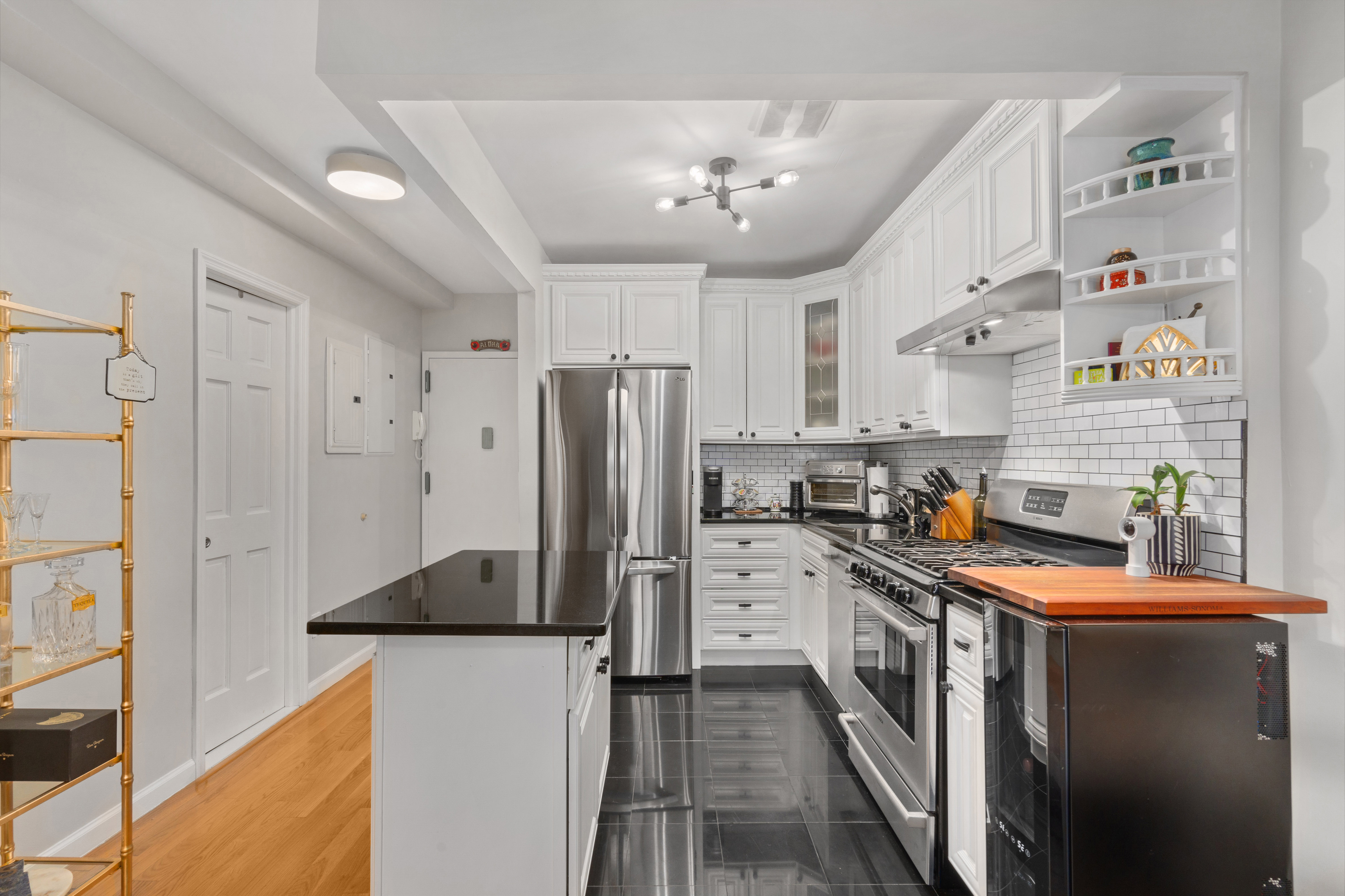 239 West 135th Street, Unit 5B Manhattan, NY 10030 - Photo 3 of 6 a kitchen with stainless steel appliances a refrigerator sink and cabinets