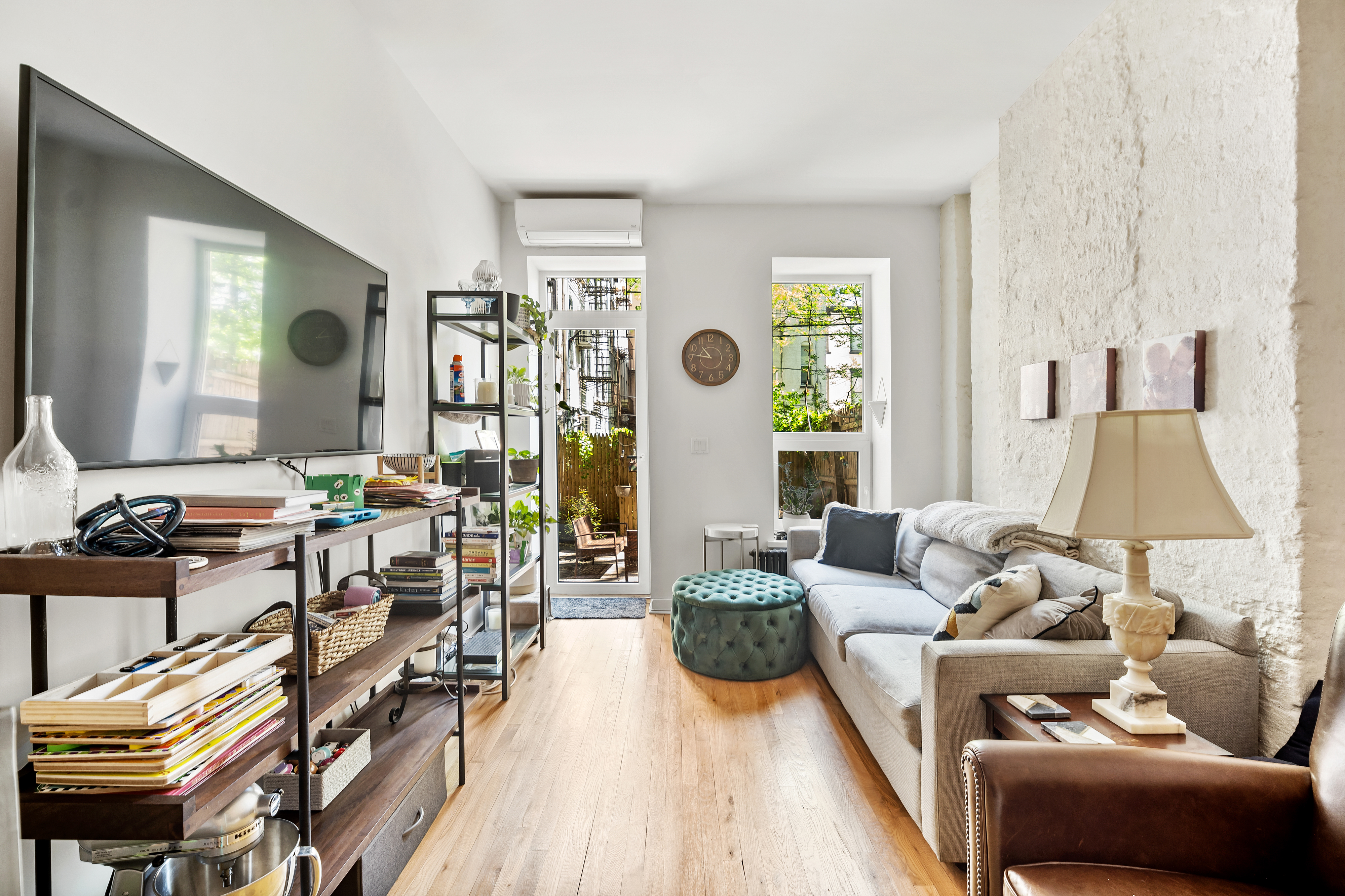 a living room with furniture and wooden floor