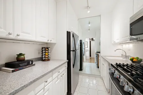 a kitchen with stainless steel appliances a sink a stove and a refrigerator