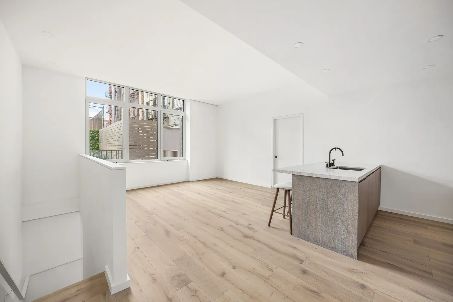 a workspace with wooden floor and windows