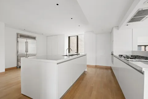 a kitchen with sink a stove and refrigerator