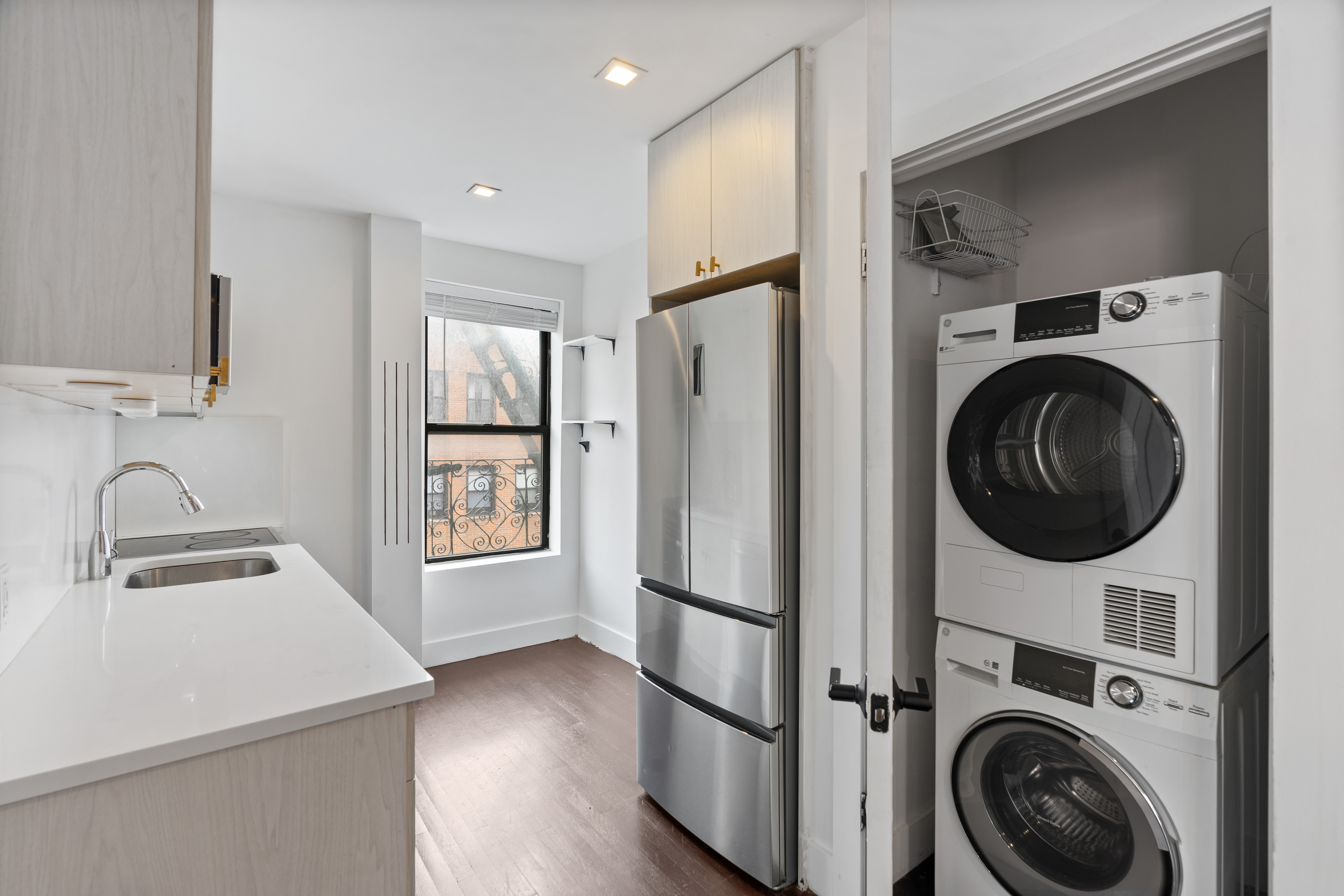140 Orchard Street, Unit 14 Manhattan, NY 10002 - Photo 7 of 9 a view of a kitchen with washer and dryer
