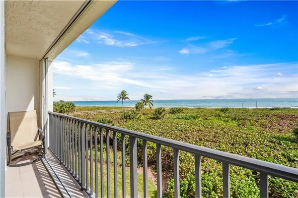 a view of a balcony with an ocean view