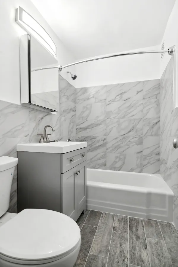 a bathroom with a sink a mirror and a toilet
