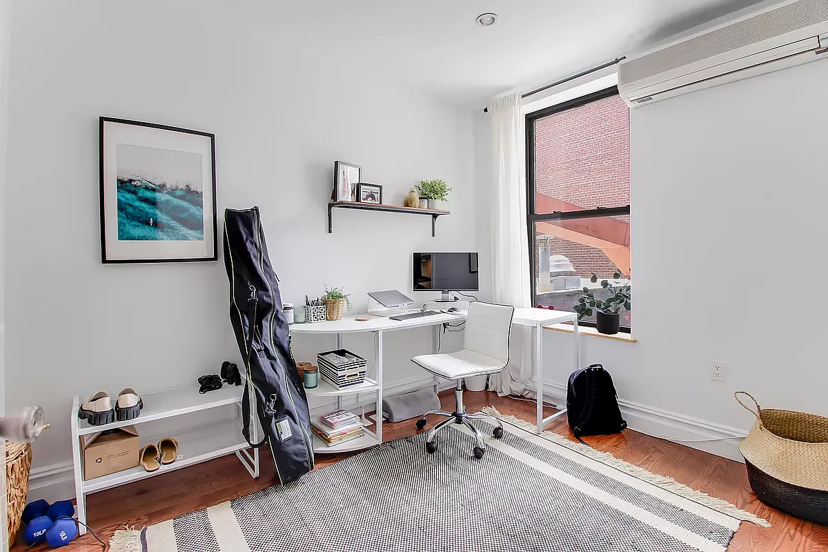 1569 2nd Avenue, Unit 301 Manhattan, NY 10028 - Photo 6 of 9 a view of a workspace with furniture and a window