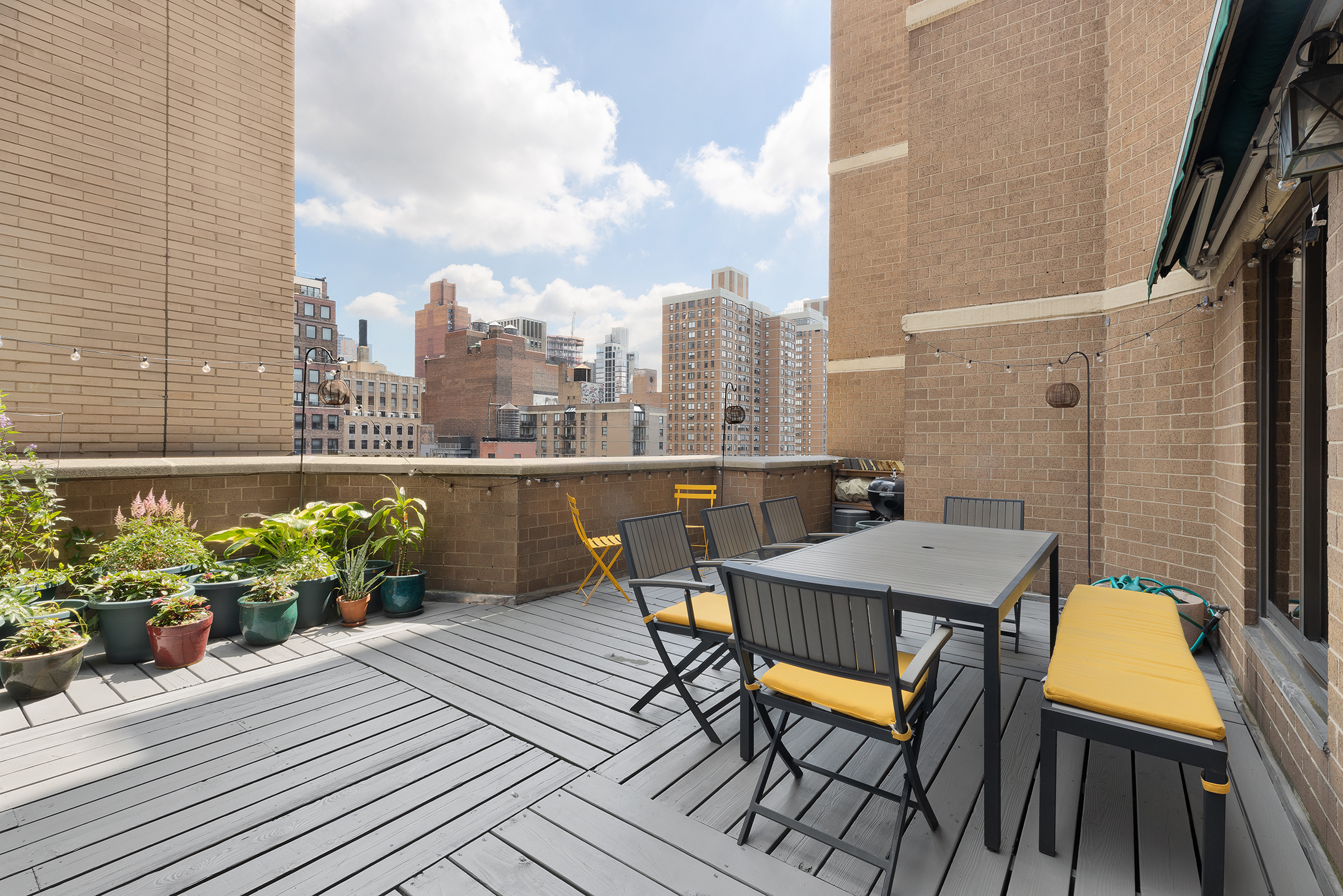 a balcony with table and chairs