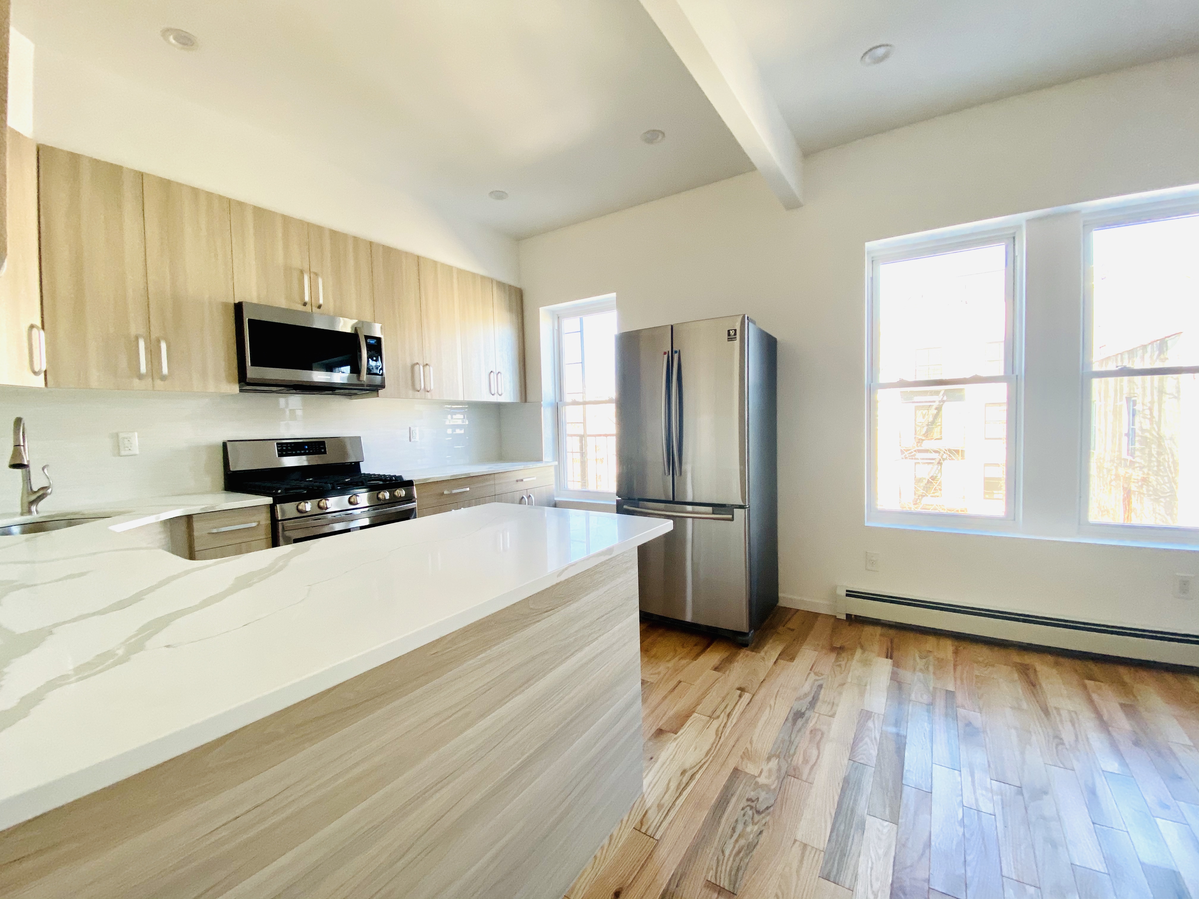175 Luquer Street, Unit 4 Brooklyn, NY 11231 - Photo 15 of 21 a kitchen with granite countertop a refrigerator stove top oven and sink