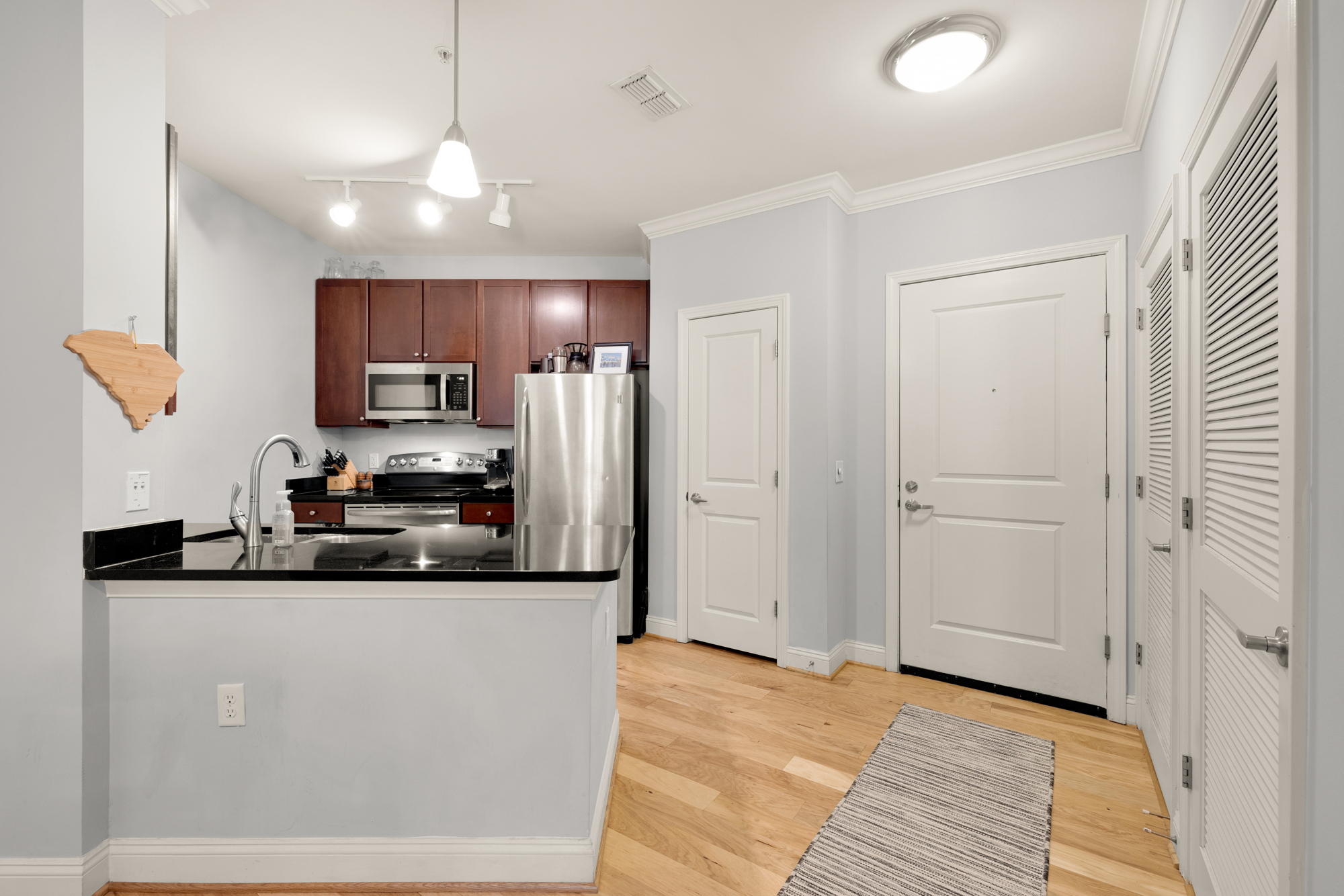 1391 Pennsylvania Ave. Southeast, Unit 324 Washington, DC 20003 - Photo 4 of 33 a kitchen with stainless steel appliances a refrigerator sink and microwave