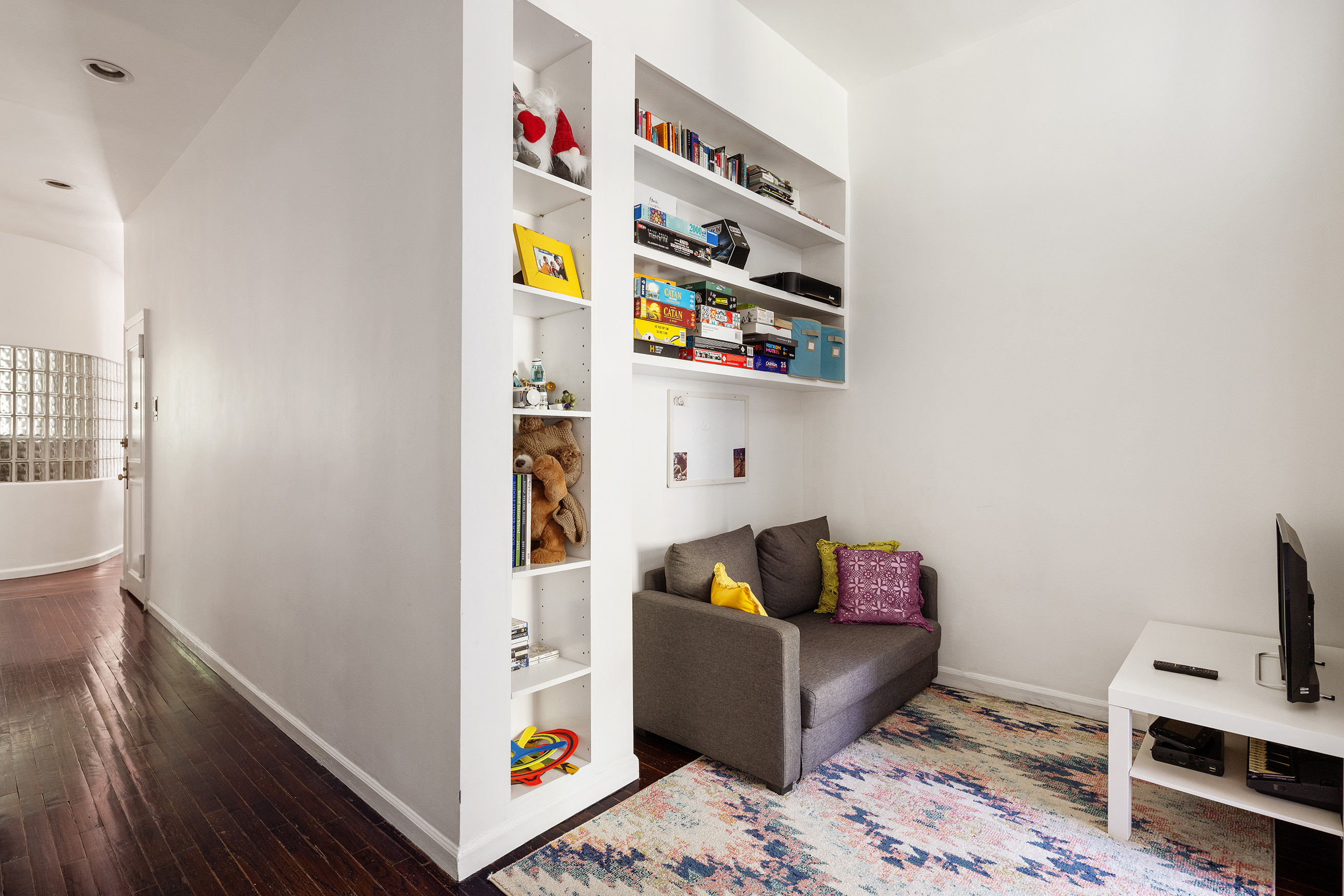 144 West 80th Street Manhattan, NY 10024 - Photo 19 of 22 a living room with furniture and a flat screen tv