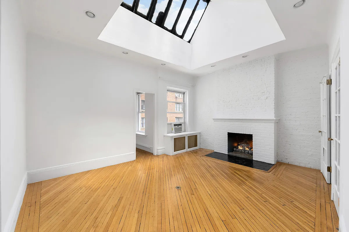 167 West 72nd Street Manhattan, NY 10023 - Photo 6 of 25 a view of empty room with wooden floor and fireplace