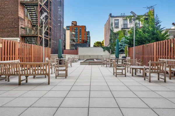 a view of roof deck with dining table and chairs with a potted plant