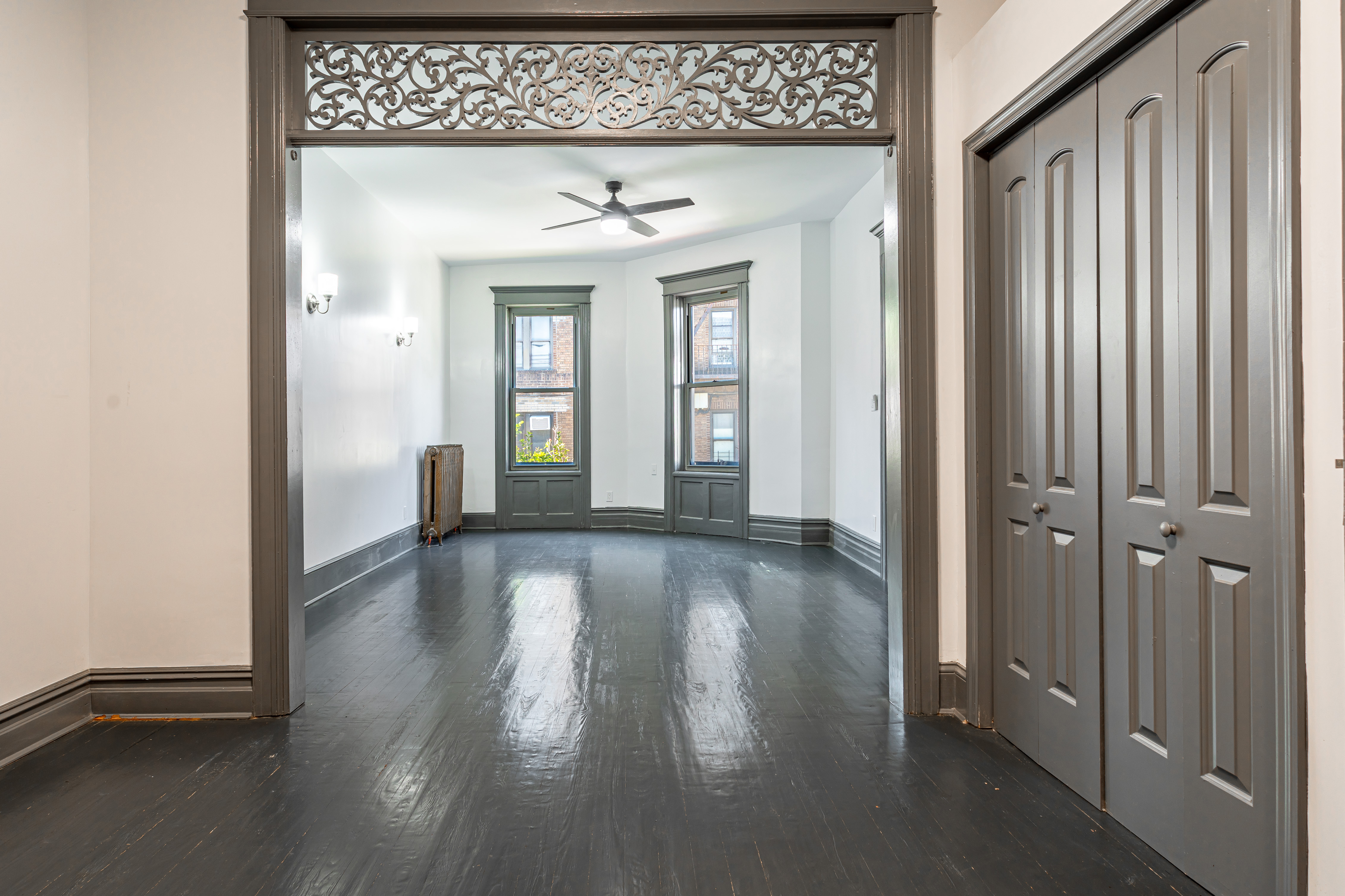 a view of a hallway with wooden floor