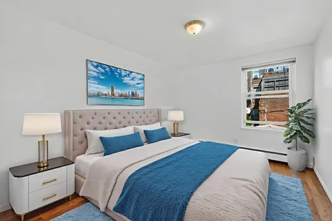 a bedroom with bed and a potted plant