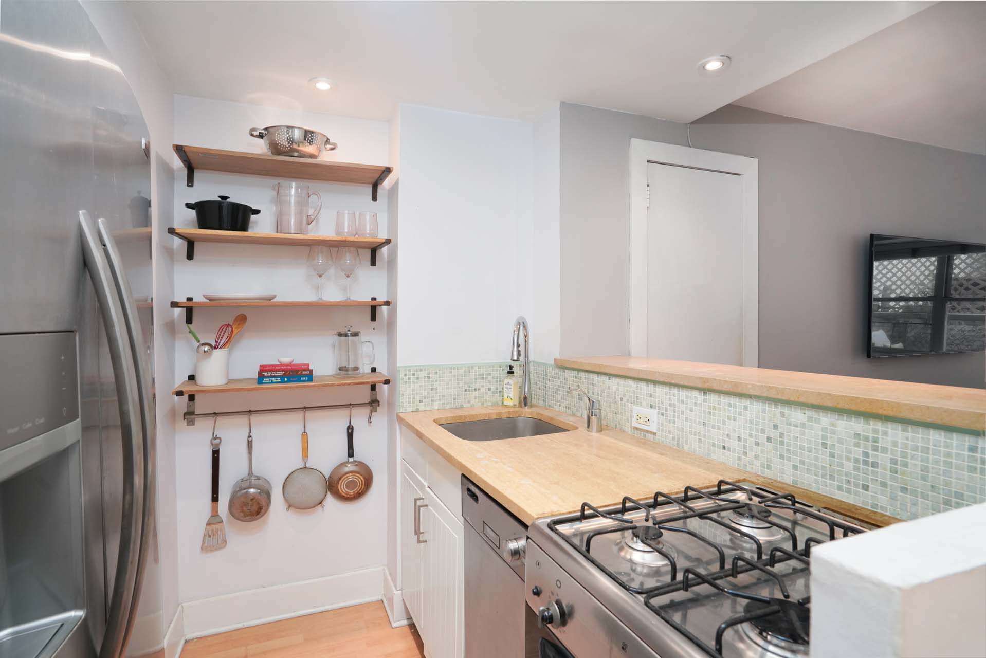 301 East 75th Street, Unit 2G Manhattan, NY 10021 - Photo 3 of 14 a kitchen with a stove and a sink