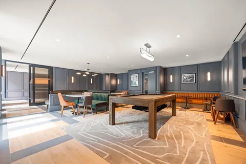 a living room with furniture a table and chairs