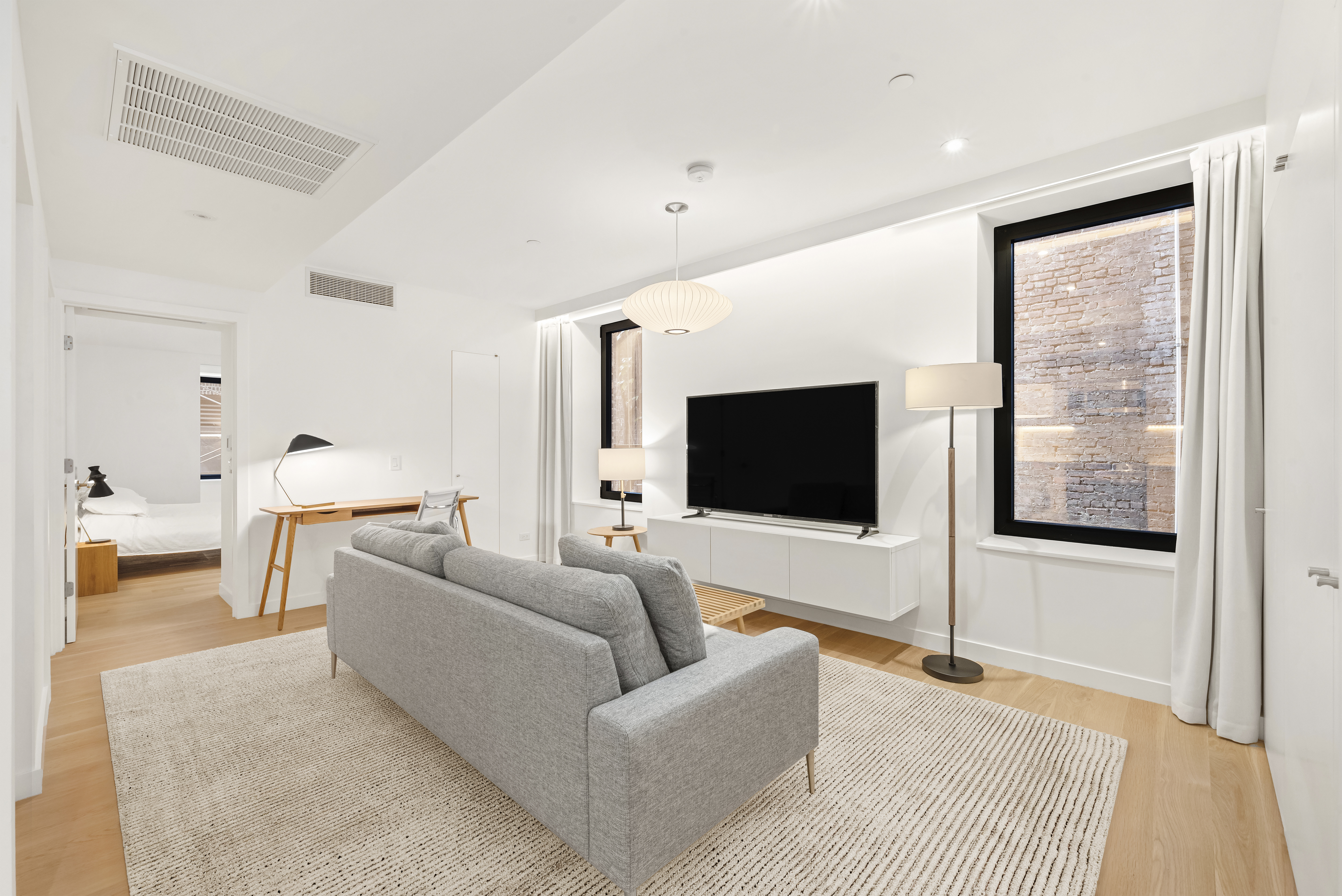 479 Washington Street, Unit 4 Manhattan, NY 10013 - Photo 4 of 8 a living room with furniture and a flat screen tv