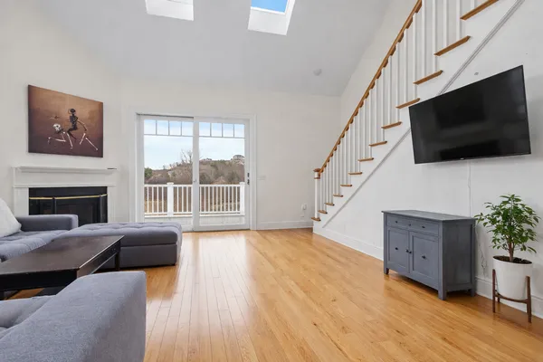 a living room with furniture a flat screen tv and a fireplace