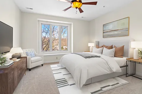 a bedroom with a large bed and a couch