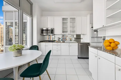 a kitchen with a sink cabinets and window