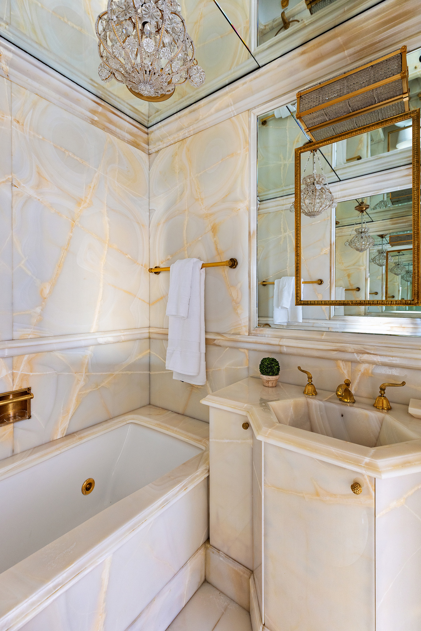 875 Park Avenue, Unit 11C Manhattan, NY 10075 - Photo 13 of 25 a bathroom with a tub sink and mirror