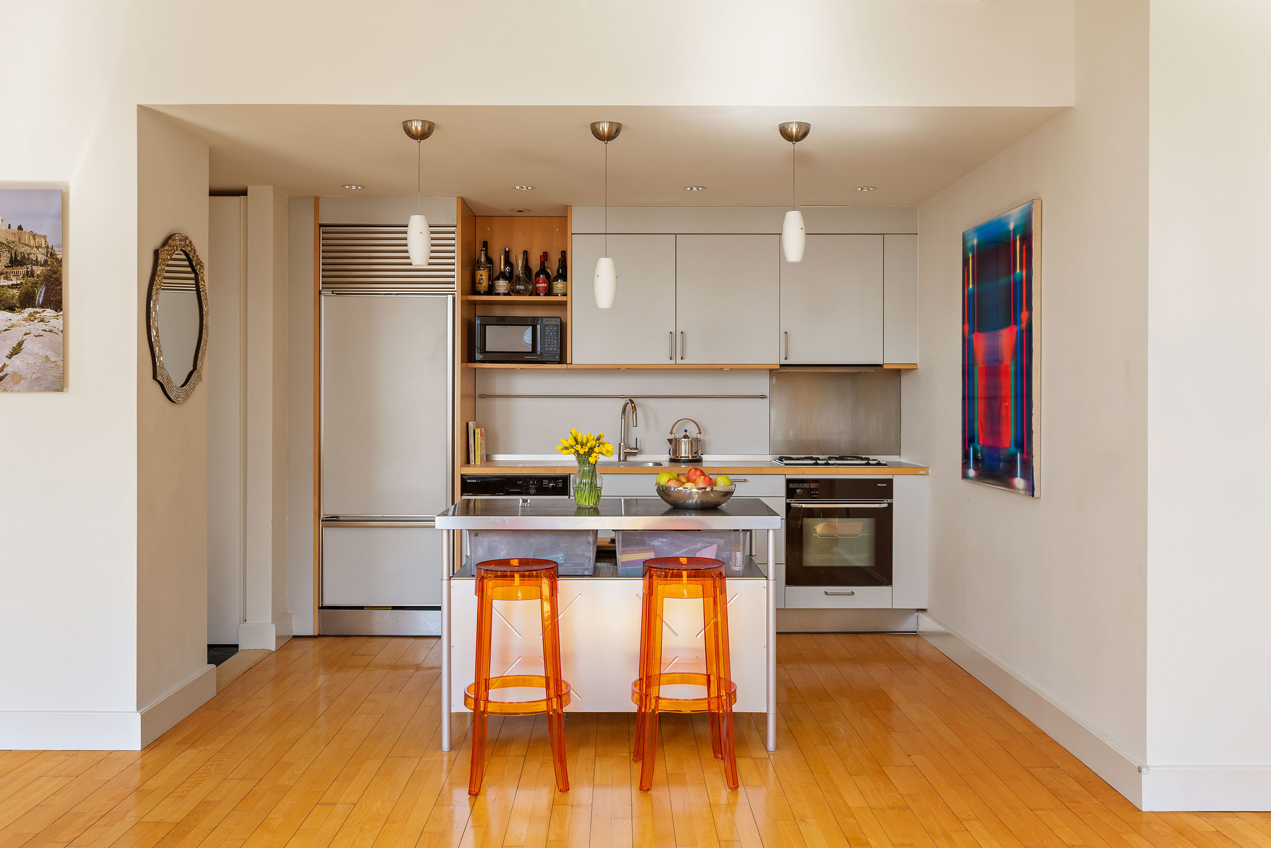 80 Chambers Street, Unit 11A Manhattan, NY 10007 - Photo 6 of 24 a kitchen with stainless steel appliances granite countertop a stove a refrigerator and a microwave