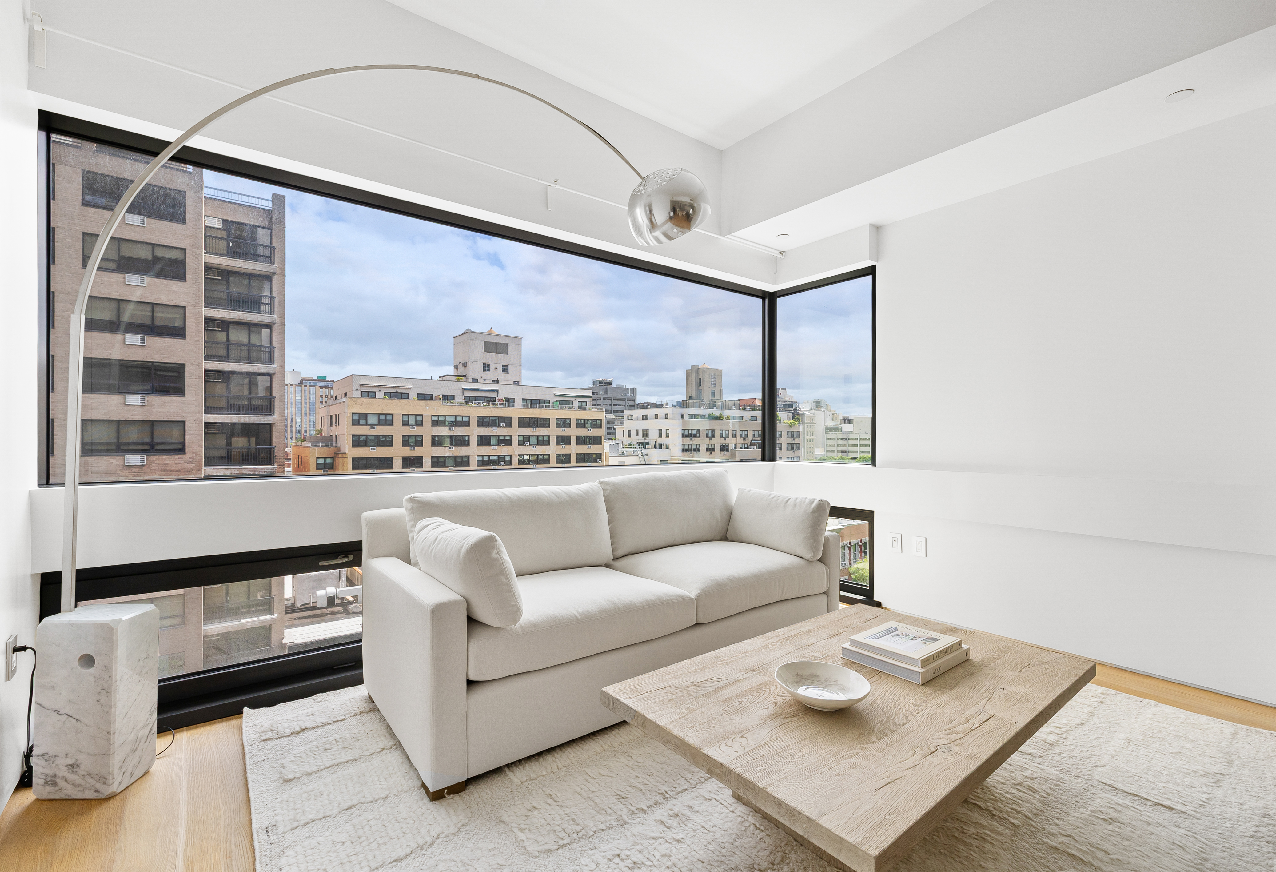 123 3rd Avenue, Unit 9C Manhattan, NY 10003 - Photo 6 of 16 a living room with furniture and a large window