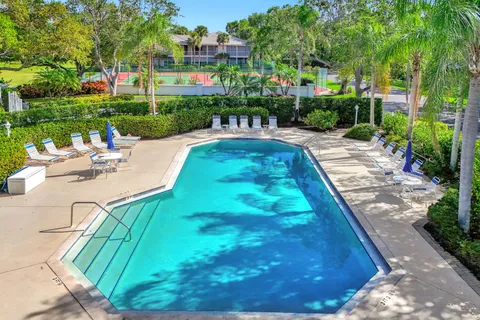 a view of yard with swimming pool and green space