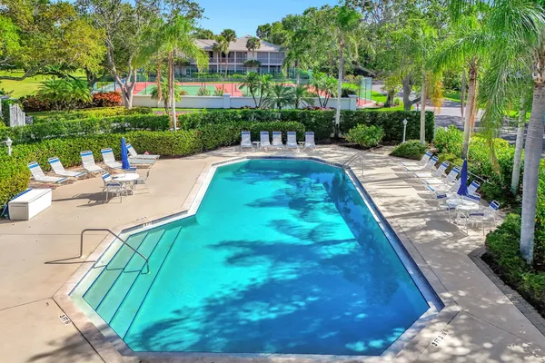 a view of yard with swimming pool and green space
