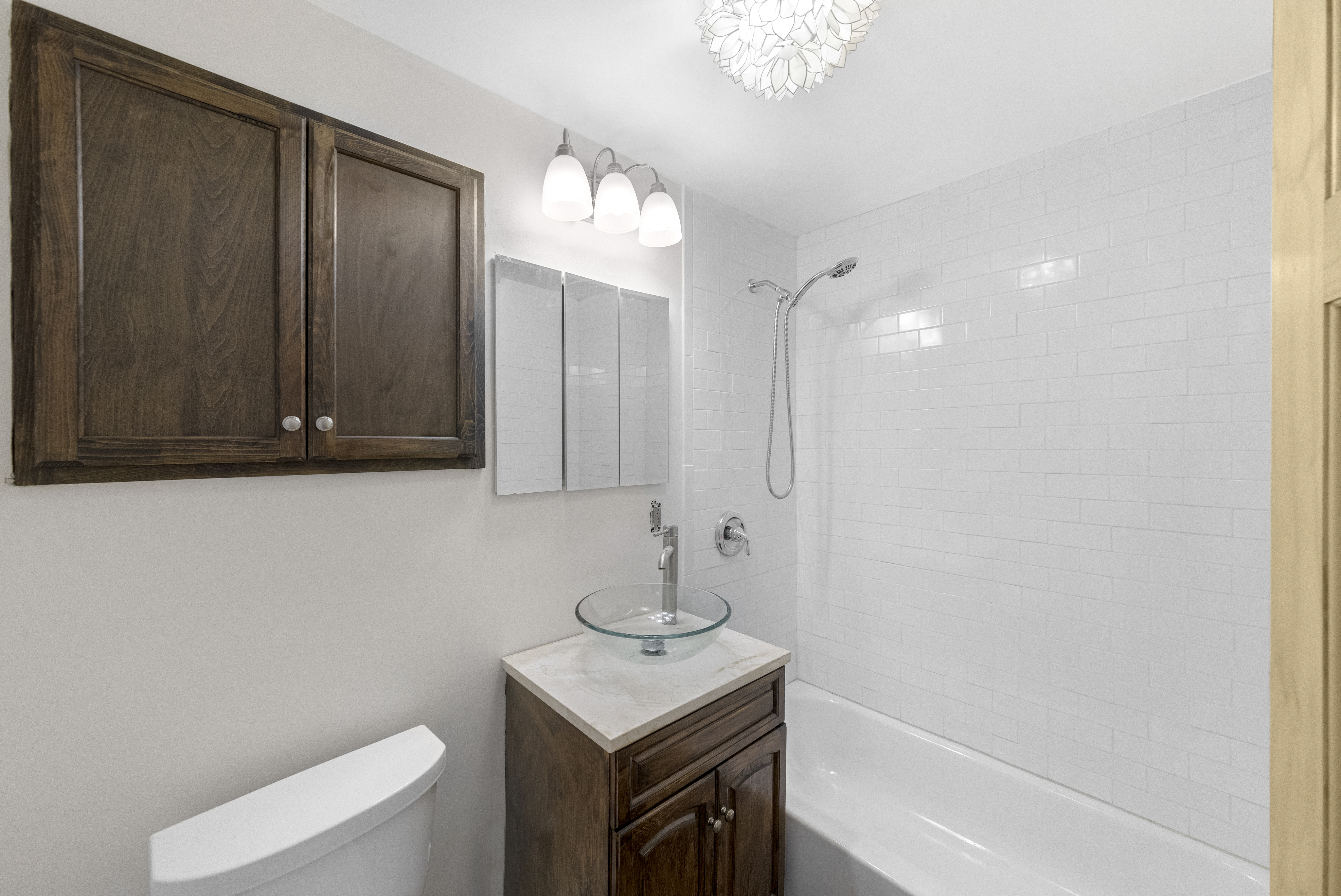 1061 Fulton Street, Unit 1 Brooklyn, NY 11238 - Photo 8 of 13 a bathroom with a sink a toilet and shower