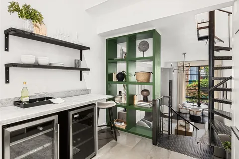 a kitchen with a sink a stove and cabinets
