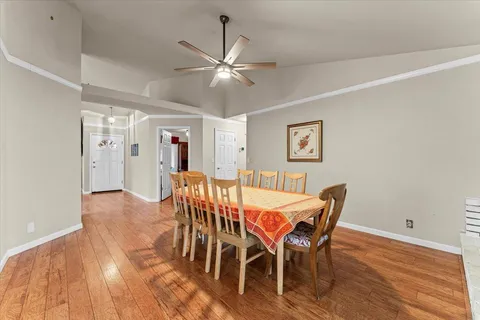 a view of a dining room with furniture and wooden floor