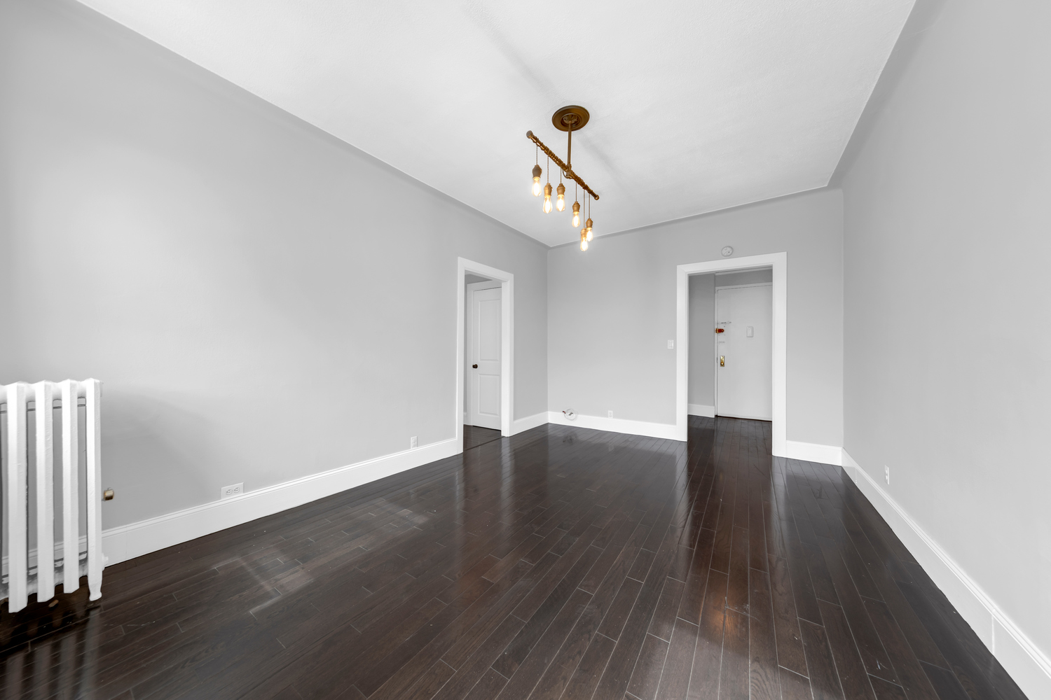 37-20 83rd Street, Unit 6J Queens, NY 11372 - Photo 4 of 14 a view of an empty room with wooden floor and a window