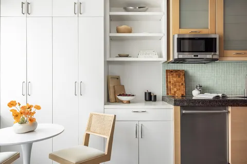 a kitchen with stainless steel appliances kitchen island granite countertop a sink a stove and a microwave