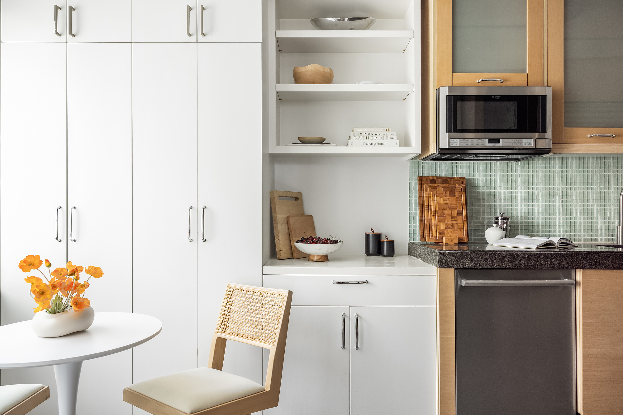 408 East 79th Street, Unit 14B Manhattan, NY 10075 - Photo 6 of 18 a kitchen with stainless steel appliances kitchen island granite countertop a sink a stove and a microwave