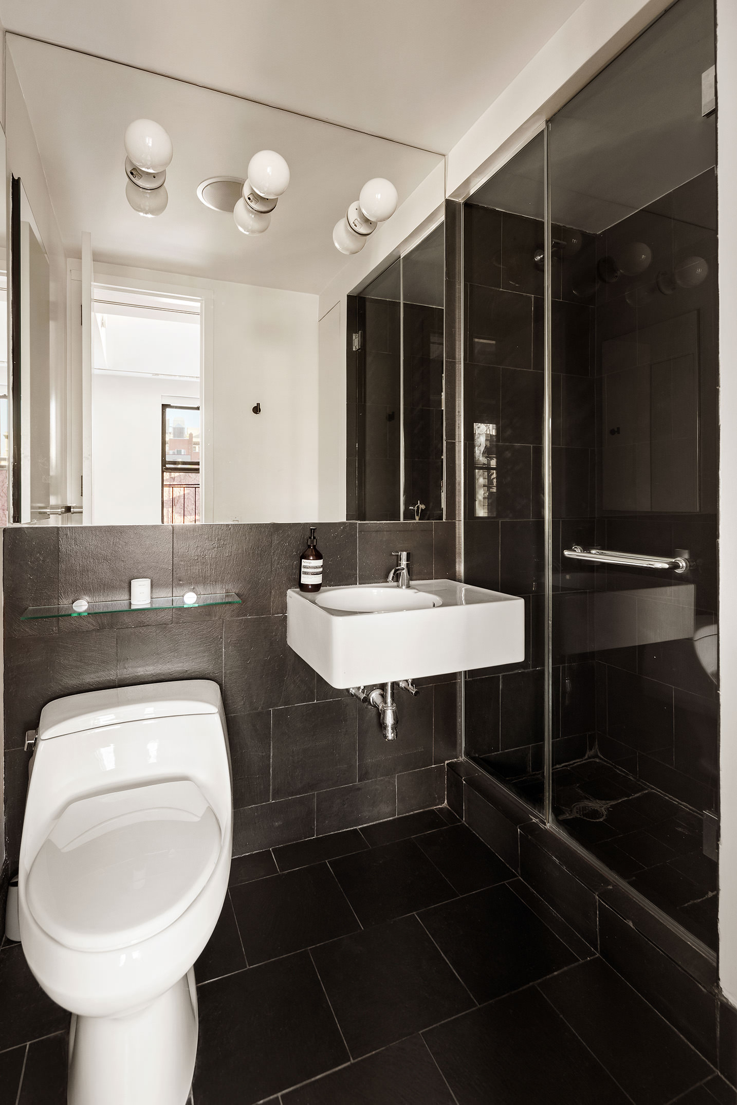 250 West 15th Street, Unit PH6E Manhattan, NY 10011 - Photo 7 of 9 a bathroom with a sink a toilet and shower