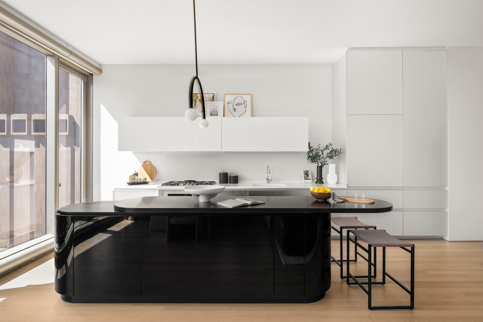 56 Leonard Street, Unit 14BEAST Manhattan, NY 10013 - Photo 3 of 35 a view of a kitchen with kitchen island stainless steel appliances a sink and a table