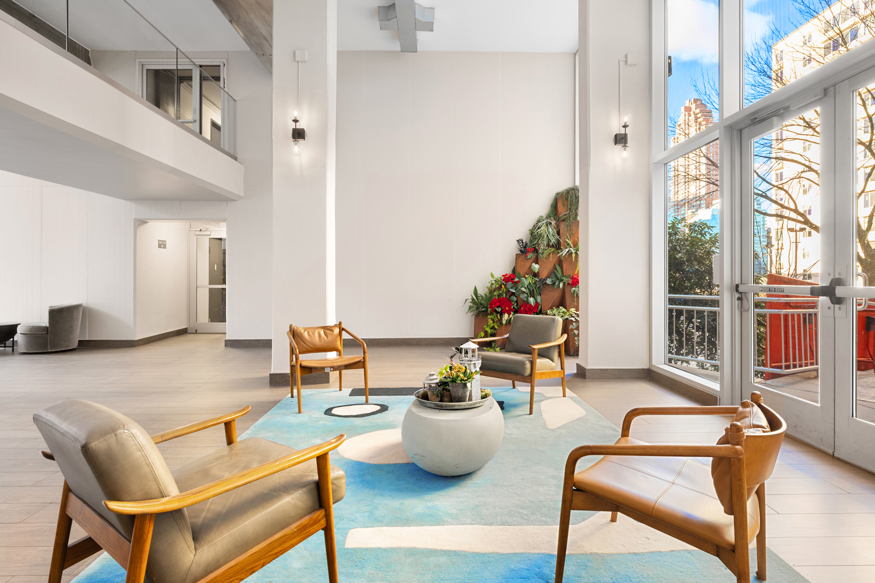 555 Main Street, Unit 1707 Manhattan, NY 10044 - Photo 3 of 4 a living room with furniture and a floor to ceiling window