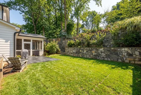a view of a house with backyard and sitting area