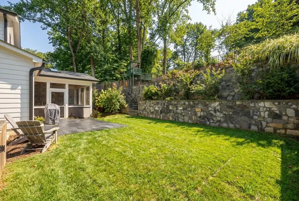 a view of a house with backyard and sitting area
